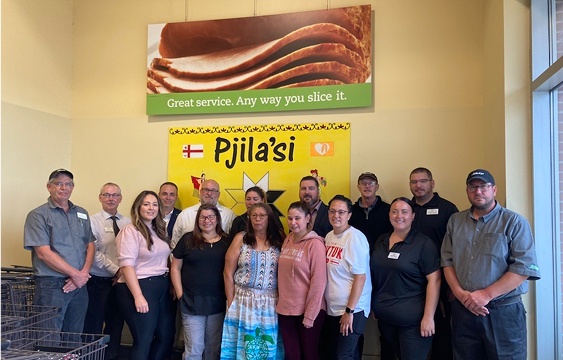 In this picture, a group of people taking a photo together.